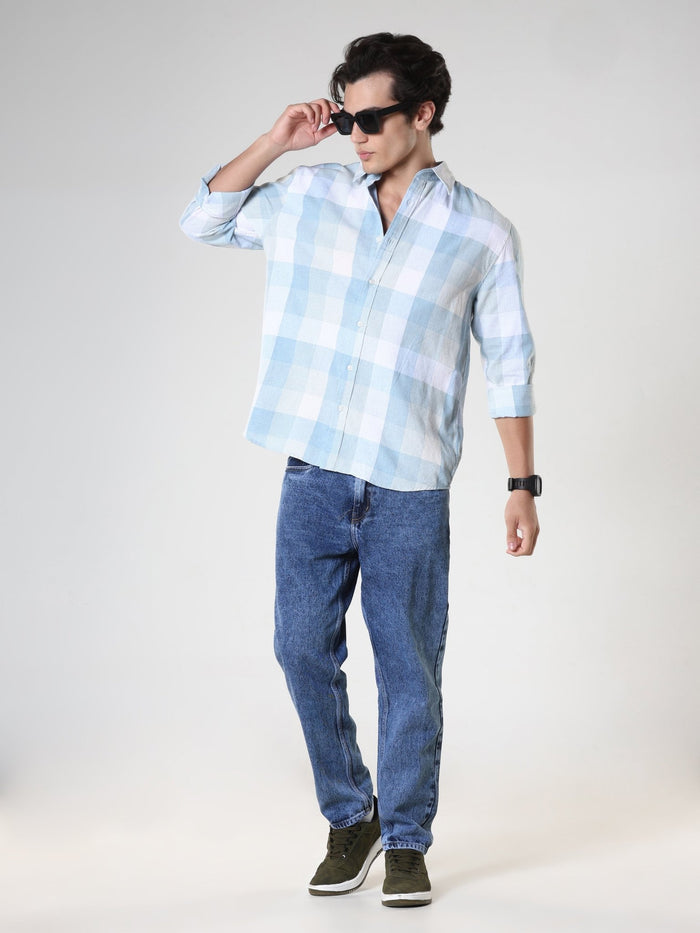 Men's casual sky blue checkered cotton shirt with full sleeves, relaxed fit – paired with denim jeans