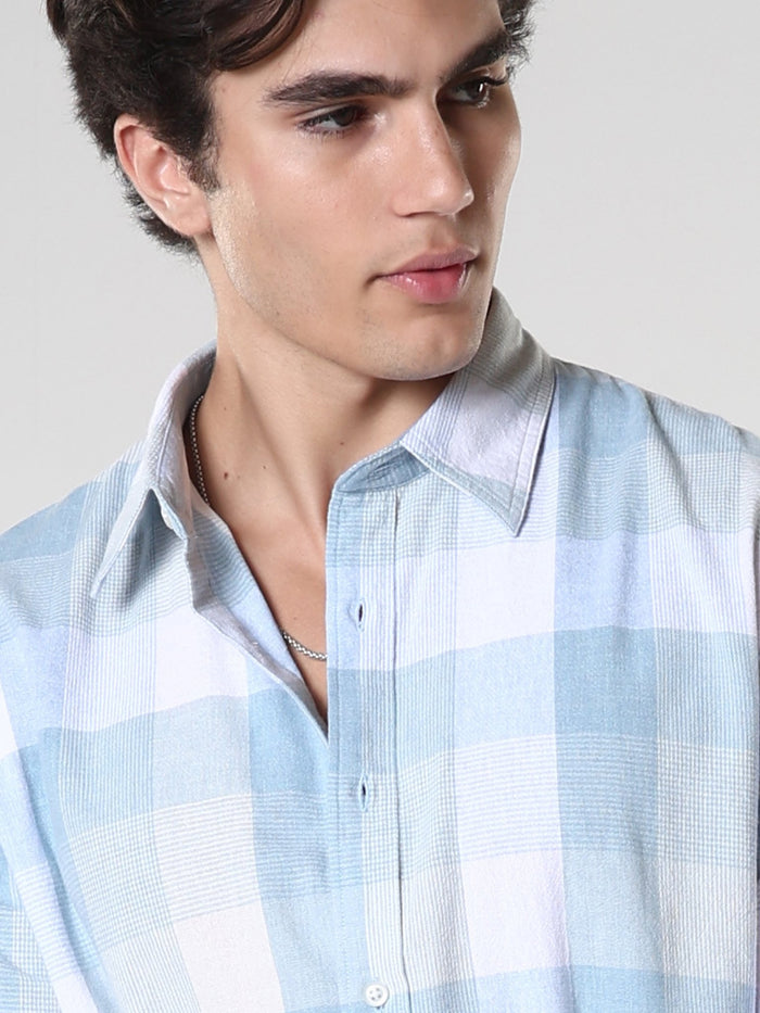 Men's casual sky blue checkered cotton shirt with full sleeves, relaxed fit – paired with denim jeans