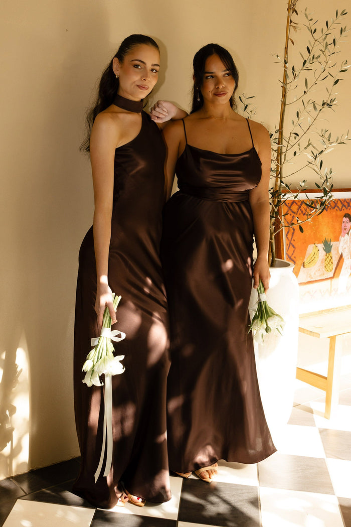 Two woman wearing brown bridesmaid dresses