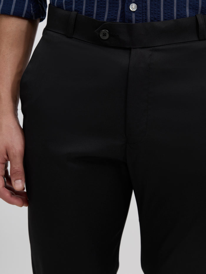men's black skinny fit trousers blended with polyster and spandex - paired with a black top and black shoes