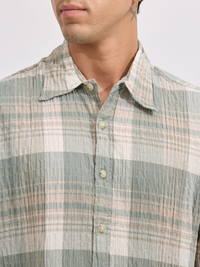 Men's oversized green checkered cotton shirt with full sleeves, styled with black jeans – casual fashion look