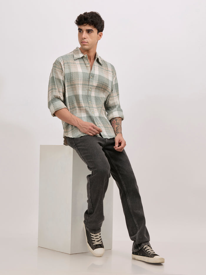 Men's oversized green checkered cotton shirt with full sleeves, styled with black jeans – casual fashion look