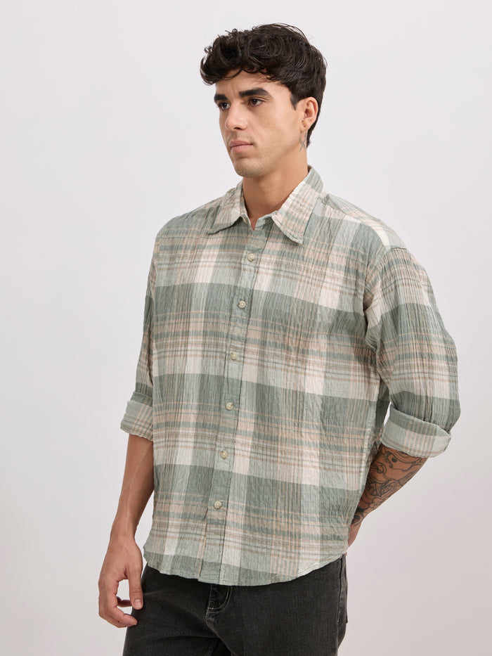 Men's oversized green checkered cotton shirt with full sleeves, styled with black jeans – casual fashion look