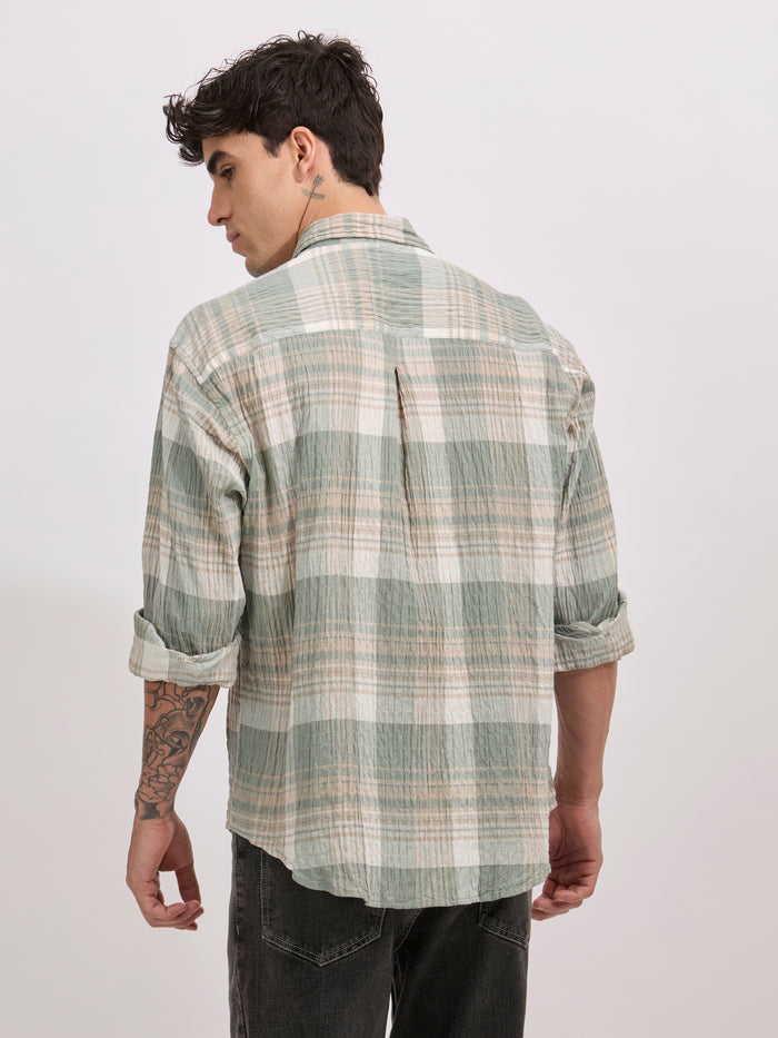 Men's oversized green checkered cotton shirt with full sleeves, styled with black jeans – casual fashion look