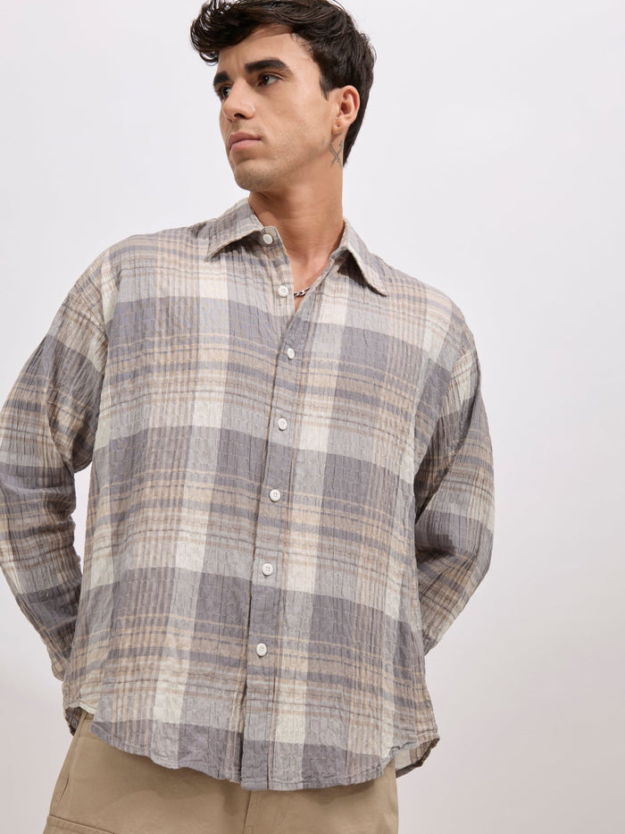 Men's oversized grey checkered cotton shirt with full sleeves, styled with beige trousers – casual fashion look