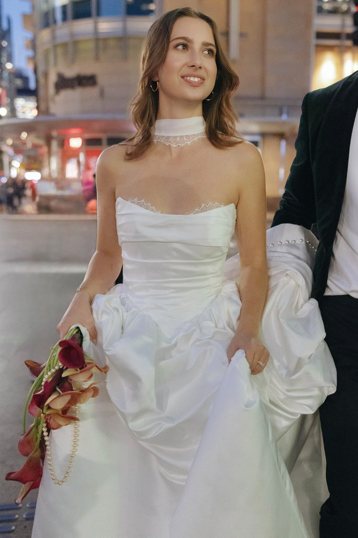 Model wearing a bridal neckscarf and wedding dress