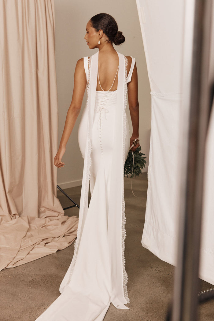 Model wearing a bridal neckscarf and wedding dress