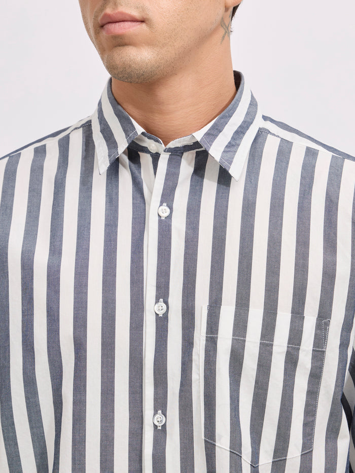 Man wearing a monochrome cotton oversized striped shirt with rolled sleeves, front pocket, and button-down collar
100% cotton