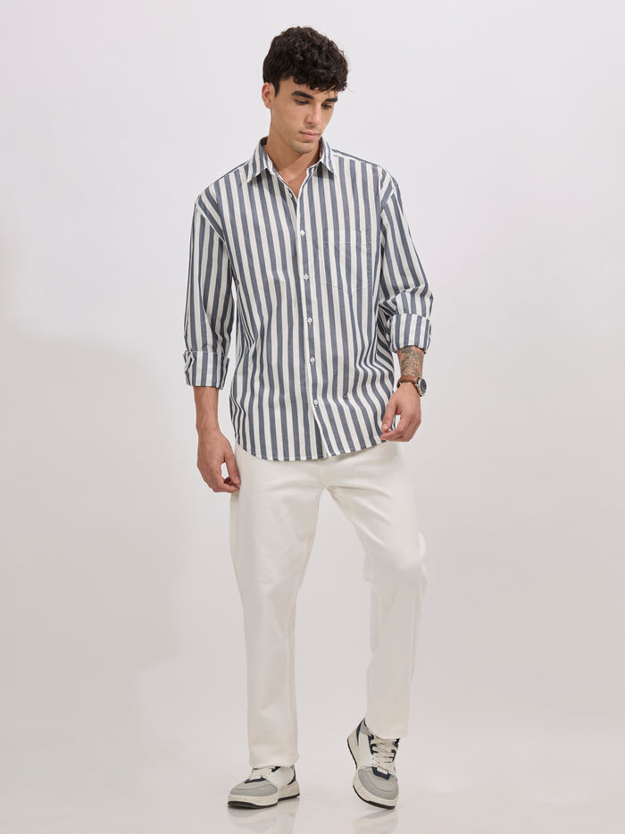Man wearing a monochrome cotton oversized striped shirt with rolled sleeves, front pocket, and button-down collar
100% cotton