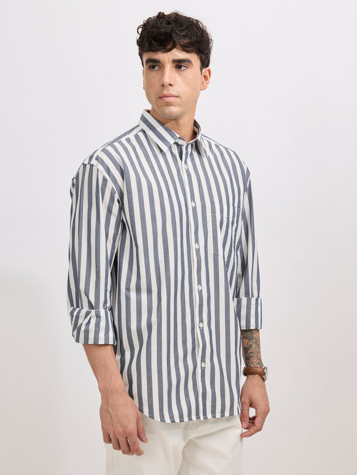 Man wearing a monochrome cotton oversized striped shirt with rolled sleeves, front pocket, and button-down collar
100% cotton